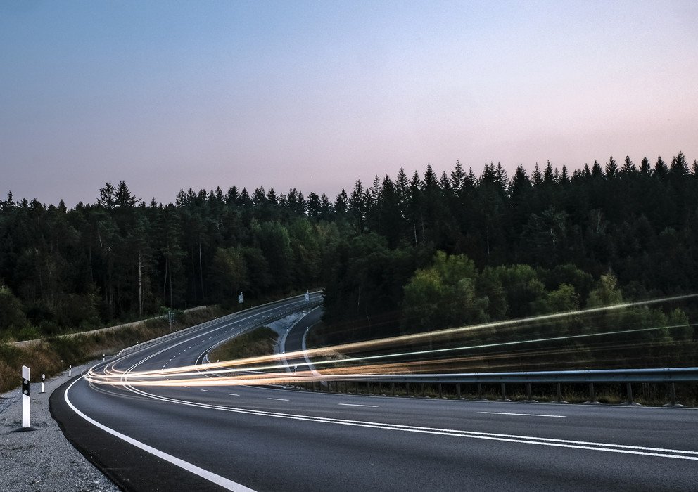 Symbolic image for mobility in rural areas. Car lights on a rural road.