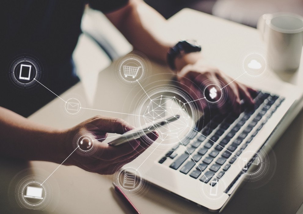 Person with mobile phone and laptop